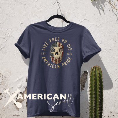 Live free or die, American pride, encircling a skull embellished with American scroll, and an American flag. The graphic is printed on an organic cotton. short sleeve, blue t-shirt. 